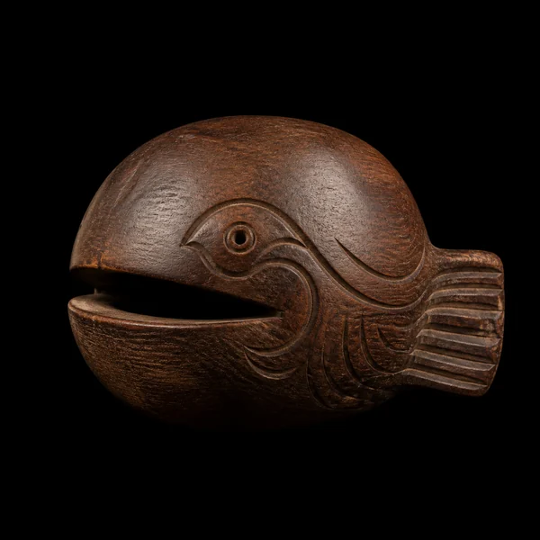 A realistic carved wooden fish on a black background